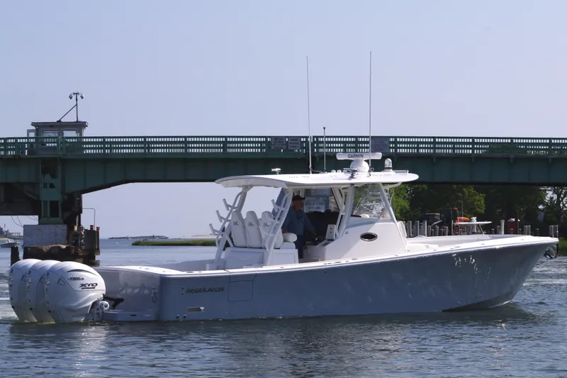 Slide: The Image of 2025 Regulator 37 boat cruising under a bridge. - 5