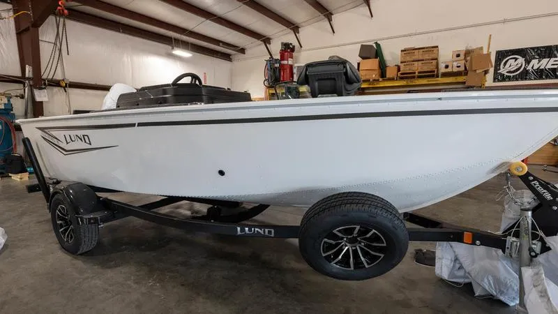 The Image of 2025 Lund 1650 Rebel XL SS boat in a warehouse on a trailer. - 0
