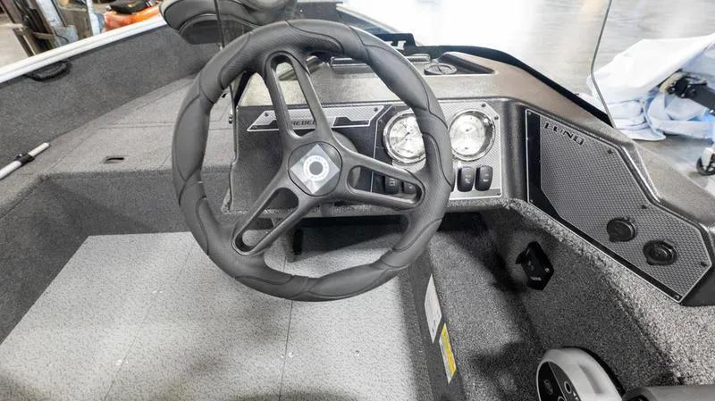 Slide: The Image of 2025 Lund 1650 Rebel XL SS boat dashboard with steering wheel and gauges. - 12