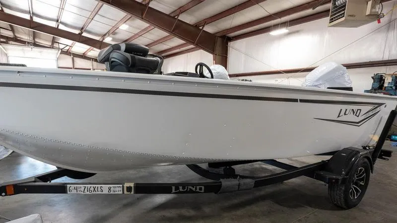 Slide: The Image of 2025 Lund 1650 Rebel XL SS boat in a warehouse on a trailer. - 15