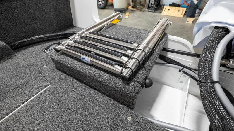 Slide: The Image of 2025 Lund 1650 Rebel XL SS boat interior with folded stainless steel ladder. - 17