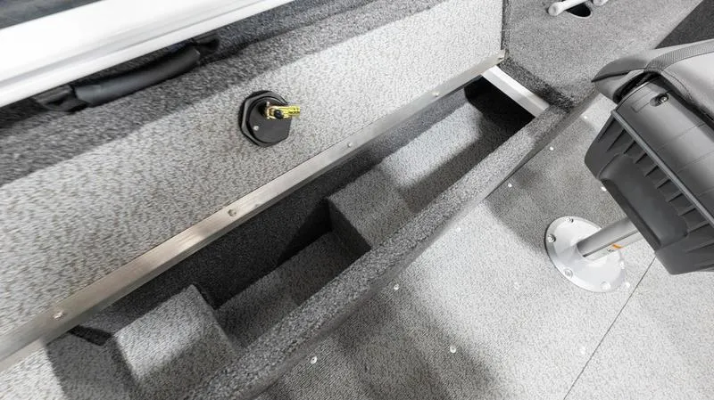 Slide: The Image of 2025 Lund 1650 Rebel XL SS boat interior with storage compartments and seating. - 2