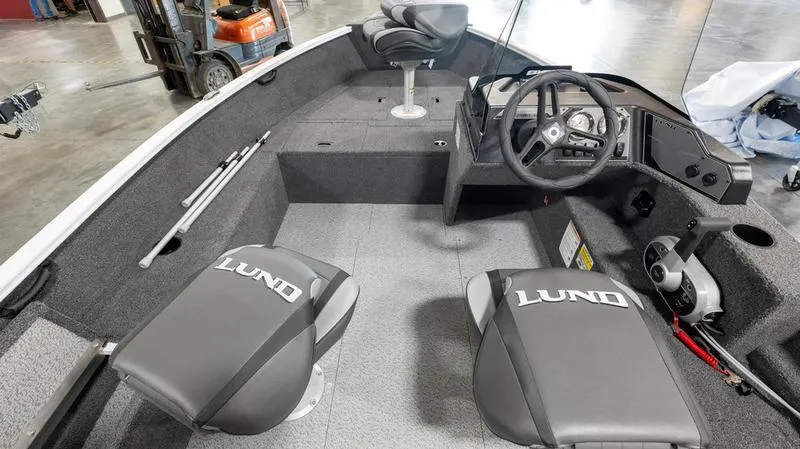 Slide: The Image of 2025 Lund 1650 Rebel XL SS boat interior with steering wheel and seating. - 6