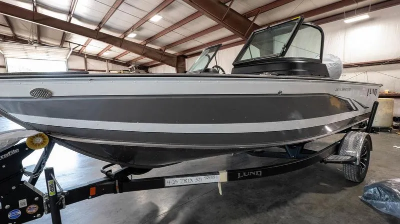 Slide: The Image of 2024 Lund 1875 Impact XS Sport boat in a warehouse. - 10
