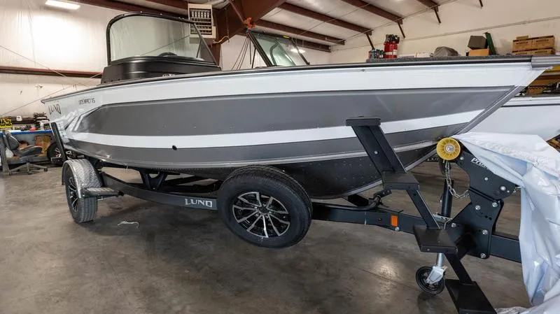 Slide: The Image of 2024 Lund 1875 Impact XS Sport boat on trailer in indoor storage. - 11