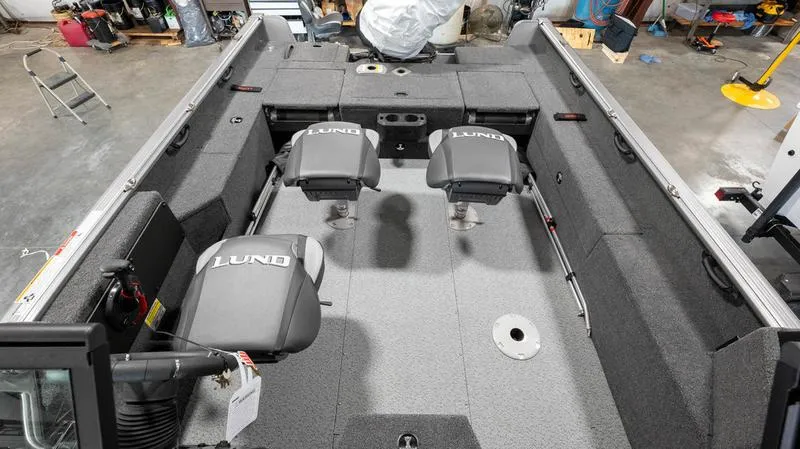 Slide: The Image of 2024 Lund 1875 Impact XS Sport boat interior with seating and storage compartments. - 15