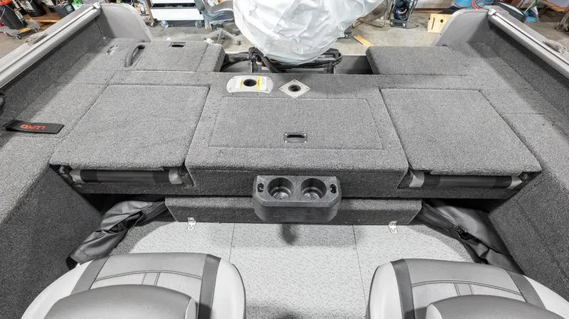 Slide: The Image of 2024 Lund 1875 Impact XS Sport boat interior with gray carpet and seating. - 17