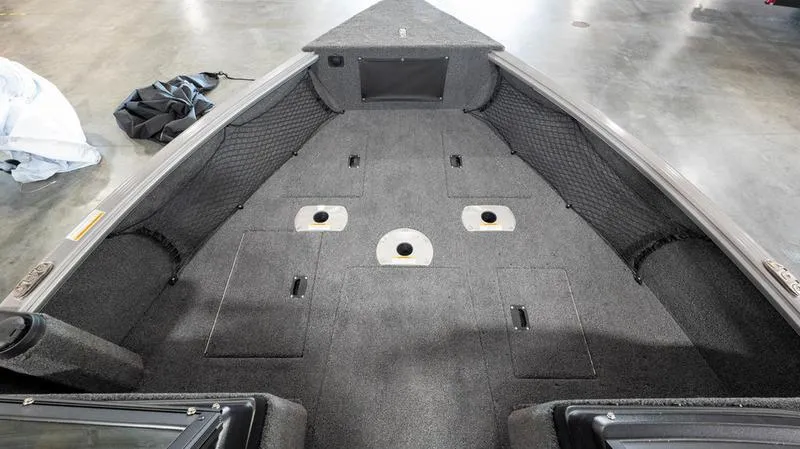 Slide: The Image of 2024 Lund 1875 Impact XS Sport boat interior with spacious deck and storage compartments. - 18