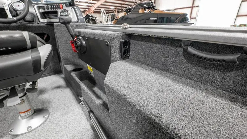 Slide: The Image of 2024 Lund 1875 Impact XS Sport boat interior with steering console and seating. - 19