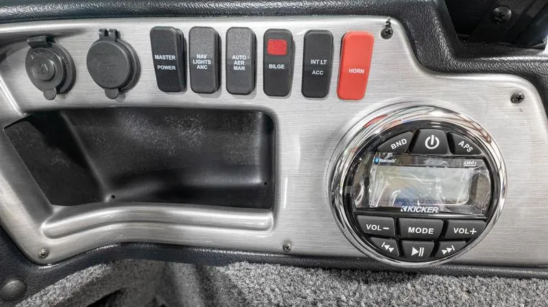 Slide: The Image of Control panel of 2024 Lund 1875 Impact XS Sport boat with switches and Kicker audio system. - 20