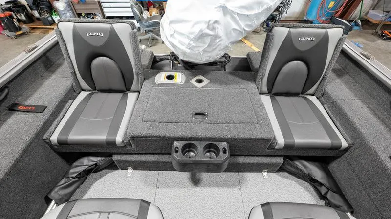 Slide: The Image of 2024 Lund 1875 Impact XS Sport boat interior with seating and storage compartments. - 21