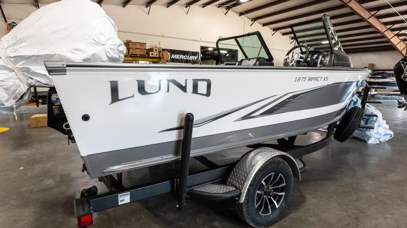 Slide: The Image of 2024 Lund 1875 Impact XS Sport boat in a warehouse. - 22
