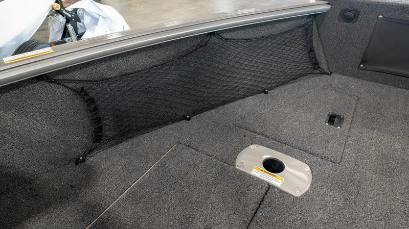 Slide: The Image of 2024 Lund 1875 Impact XS Sport boat interior with storage net and carpeted floor. - 28
