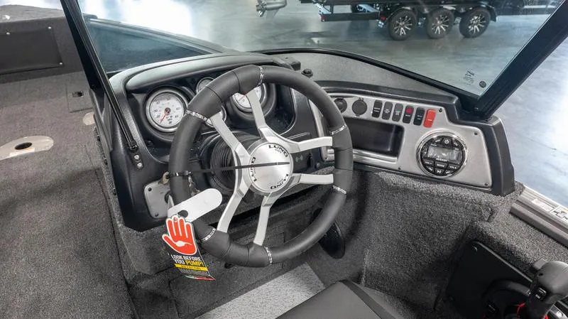 Slide: The Image of 2024 Lund 1875 Impact XS Sport boat dashboard and steering wheel. - 7