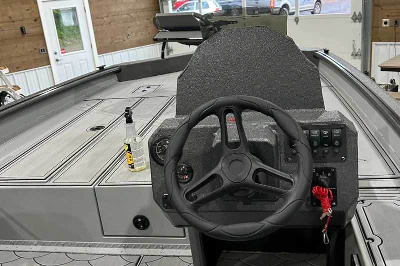 Slide: The Image of 2024 SeaArk FLEX21 boat interior with steering wheel and control panel. - 3