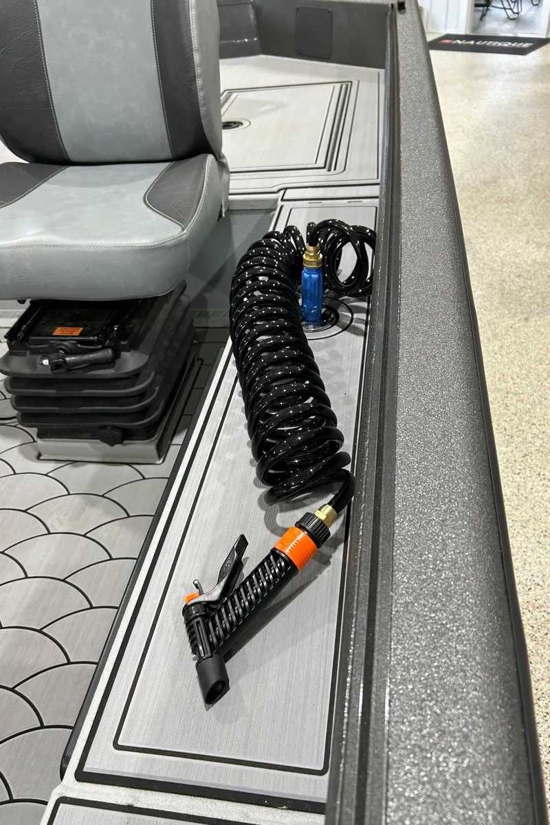 Slide: The Image of 2024 SeaArk FLEX21 boat interior with coiled hose and seating. - 5