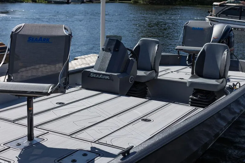 Slide: The Image of 2024 SeaArk FLEX21 boat with spacious seating on a calm lake. - 6