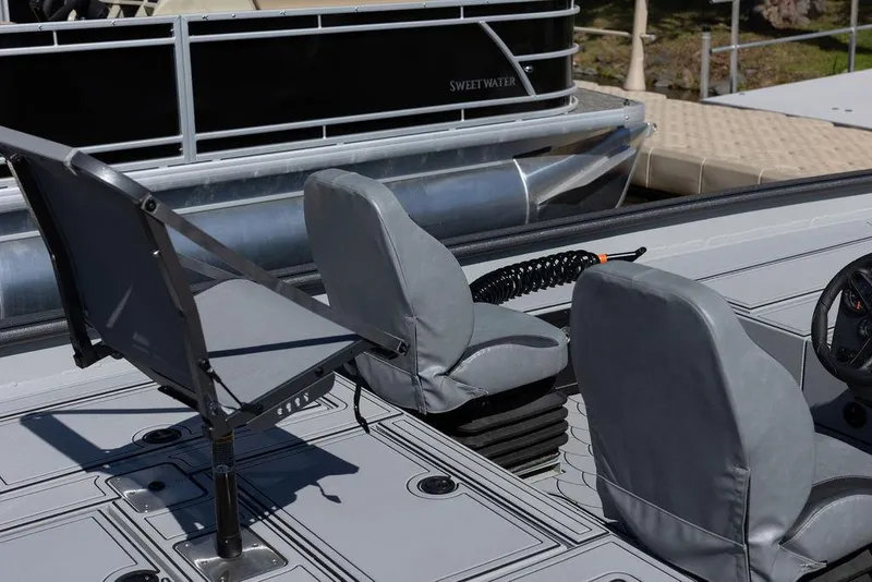 Slide: The Image of 2024 SeaArk FLEX21 boat interior with gray seating and control panel. - 8