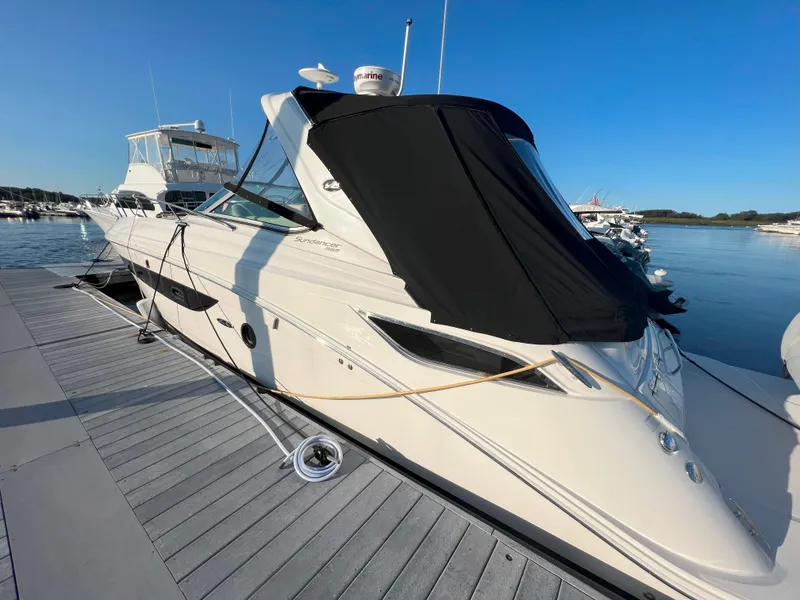 Slide: The Image of 2014 Sea Ray 350 Sundancer yacht docked at marina under clear blue sky. - 1