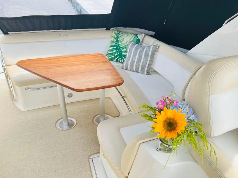 Slide: The Image of Luxurious 2014 Sea Ray 350 Sundancer interior with cozy seating and elegant wooden table. - 10