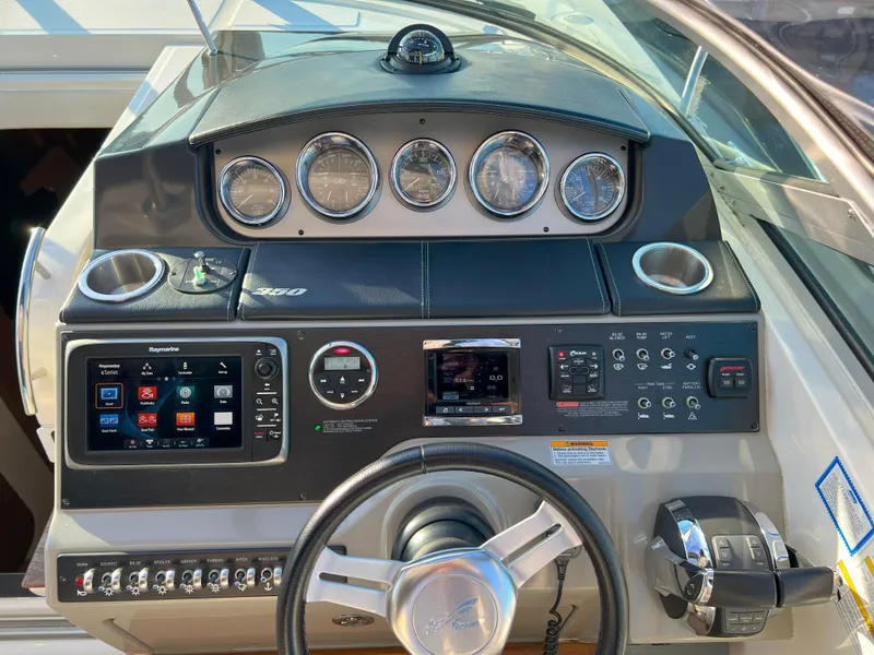 Slide: The Image of Control panel of a 2014 Sea Ray 350 Sundancer boat with gauges and navigation system. - 12