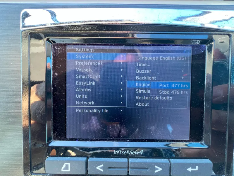 Slide: The Image of VesselView4 display on 2014 Sea Ray 350 Sundancer showing engine hours and settings menu. - 13