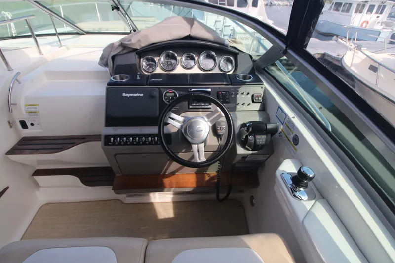 Slide: The Image of 2014 Sea Ray 350 Sundancer helm with modern controls and gauges. - 16