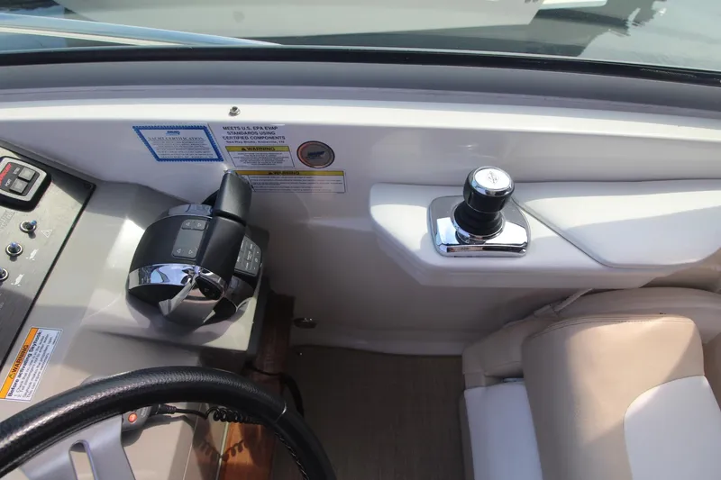 Slide: The Image of 2014 Sea Ray 350 Sundancer helm with controls and seating. - 19