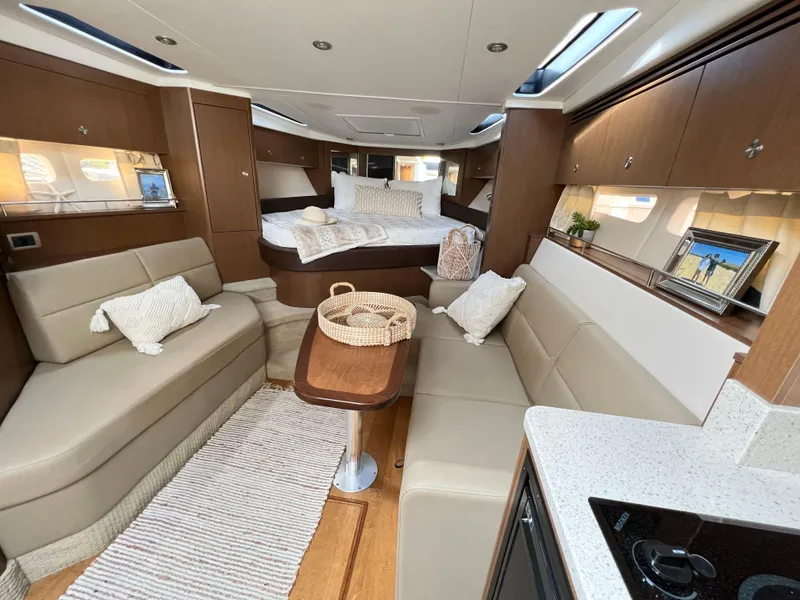 Slide: The Image of Luxurious interior of 2014 Sea Ray 350 Sundancer yacht with cozy seating and elegant decor. - 28