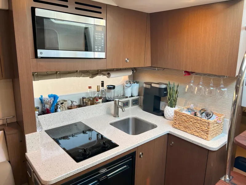 Slide: The Image of Modern kitchen in 2014 Sea Ray 350 Sundancer yacht with appliances and countertop. - 29