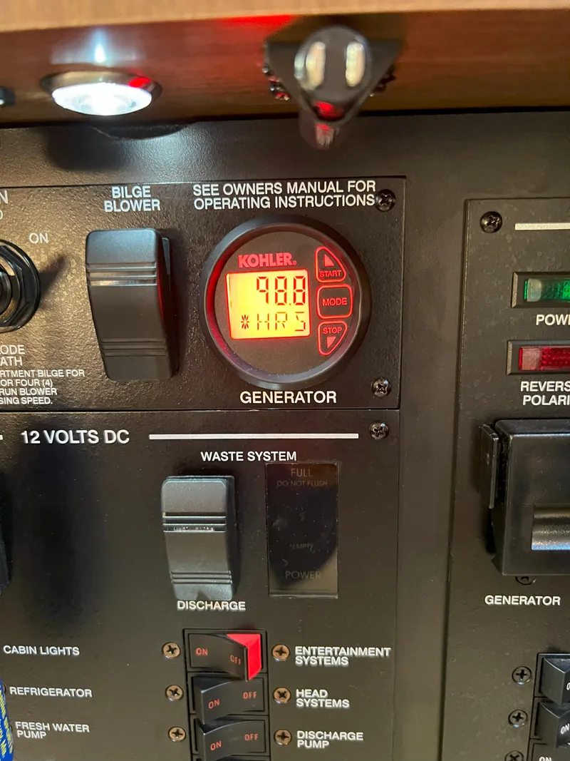 Slide: The Image of Control panel of a 2014 Sea Ray 350 Sundancer boat, featuring generator display. - 32