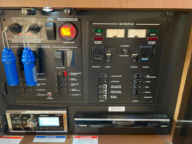 Slide: The Image of Electrical control panel of a 2014 Sea Ray 350 Sundancer boat, featuring various switches and gauges. - 33