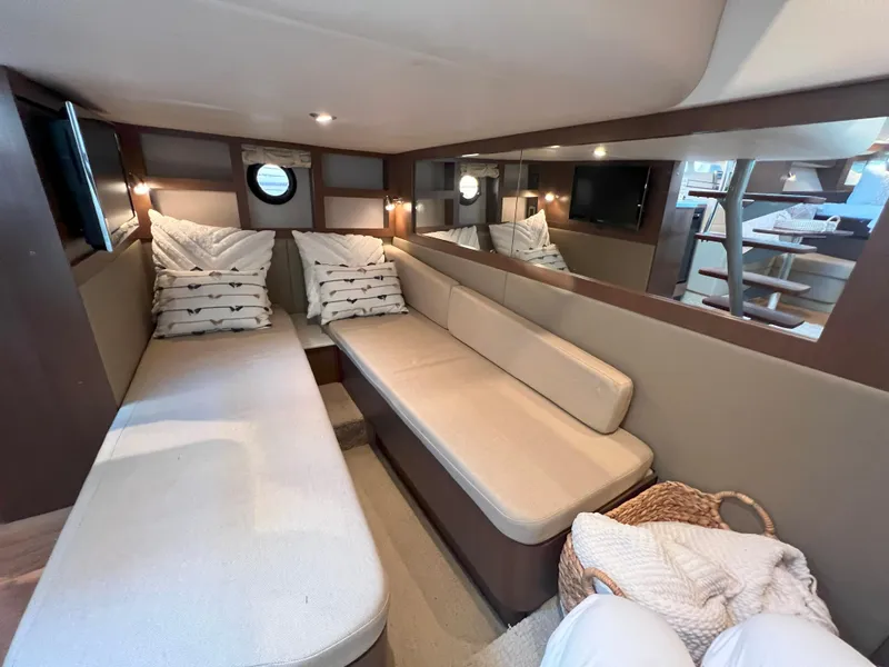 Slide: The Image of Interior of 2014 Sea Ray 350 Sundancer yacht with cozy seating and modern decor. - 36