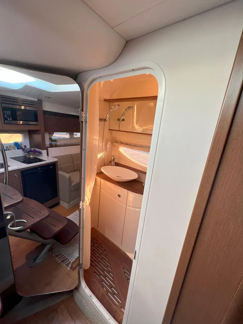 Slide: The Image of Interior view of 2014 Sea Ray 350 Sundancer yacht bathroom and cabin area. - 41