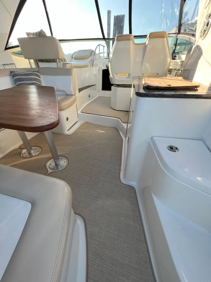 Slide: The Image of Interior of 2014 Sea Ray 350 Sundancer yacht with seating and table. - 45