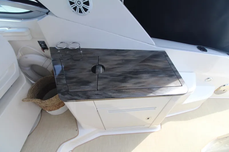 Slide: The Image of 2014 Sea Ray 350 Sundancer interior with sleek countertop and storage. - 48