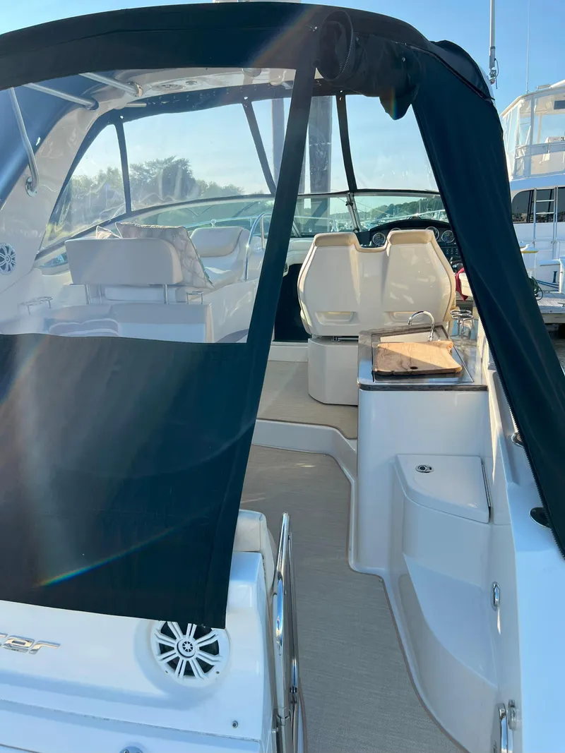 Slide: The Image of 2014 Sea Ray 350 Sundancer boat interior with seating and canopy. - 6