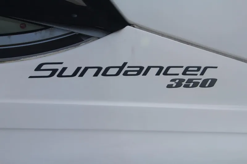 Slide: The Image of 2014 Sea Ray 350 Sundancer boat logo on white surface. - 7