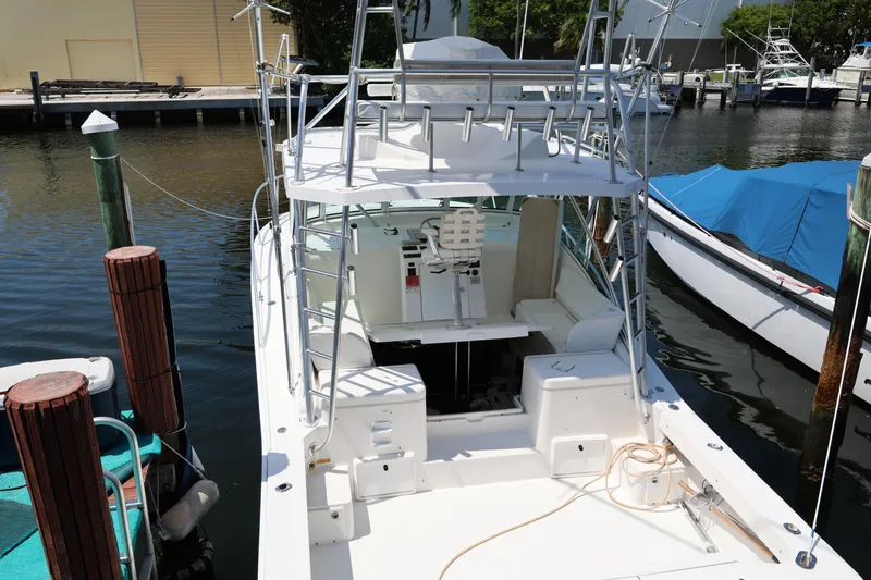 Slide: The Image of 2007 Luhrs 32 Open boat docked, featuring spacious deck and fishing rod holders. - 10