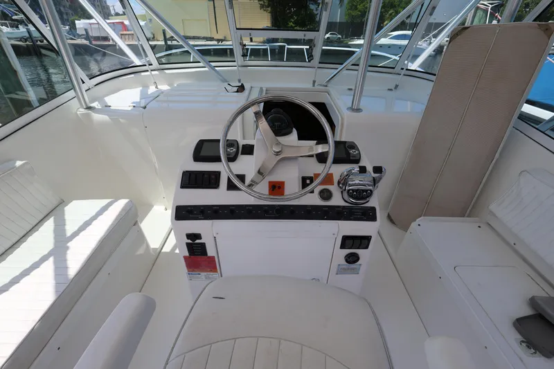 Slide: The Image of 2007 Luhrs 32 Open boat helm station with steering wheel and control panel. - 14