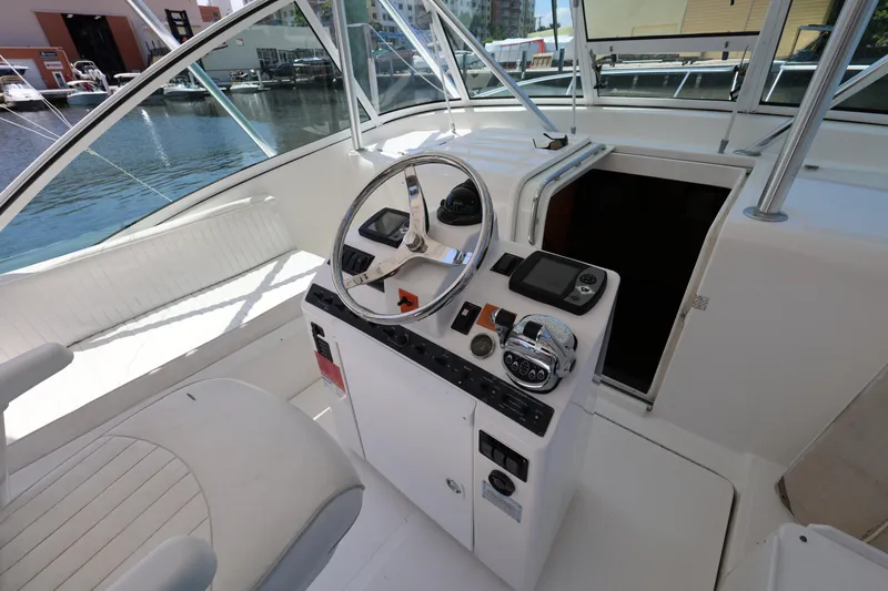 Slide: The Image of 2007 Luhrs 32 Open boat helm station with steering wheel and controls. - 17