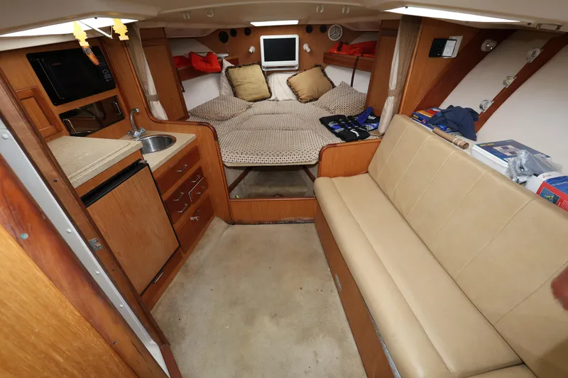 Slide: The Image of 2007 Luhrs 32 Open cabin interior with kitchenette, seating, and bed. - 24