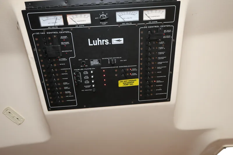 Slide: The Image of Control panel of a 2007 Luhrs 32 Open boat with gauges and switches. - 31