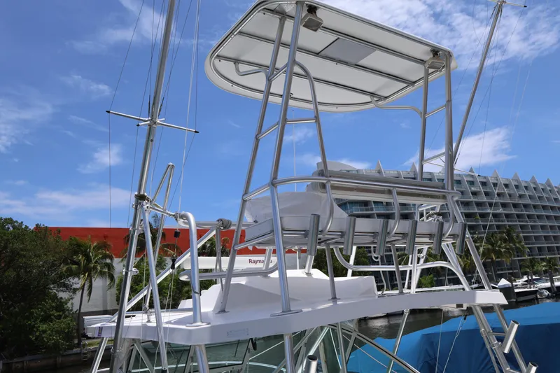 Slide: The Image of 2007 Luhrs 32 Open boat with a flybridge, docked near modern buildings. - 8