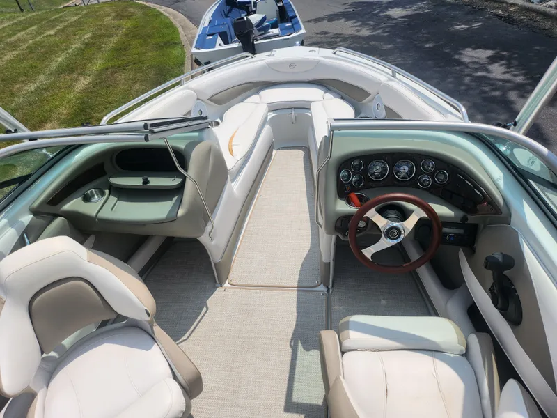 Slide: The Image of 2014 Crownline 21 SS boat interior with steering wheel and seating. - 11