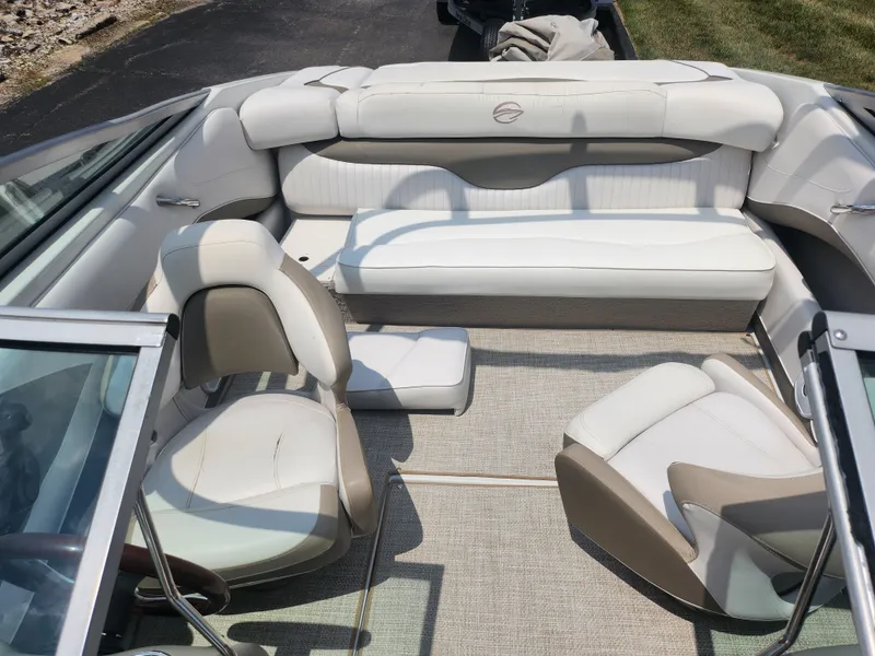 Slide: The Image of 2014 Crownline 21 SS boat interior with white and beige seating. - 19