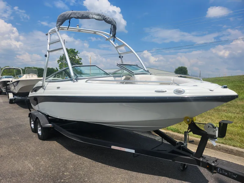 Slide: The Image of 2014 Crownline 21 SS boat on a trailer under a blue sky. - 5