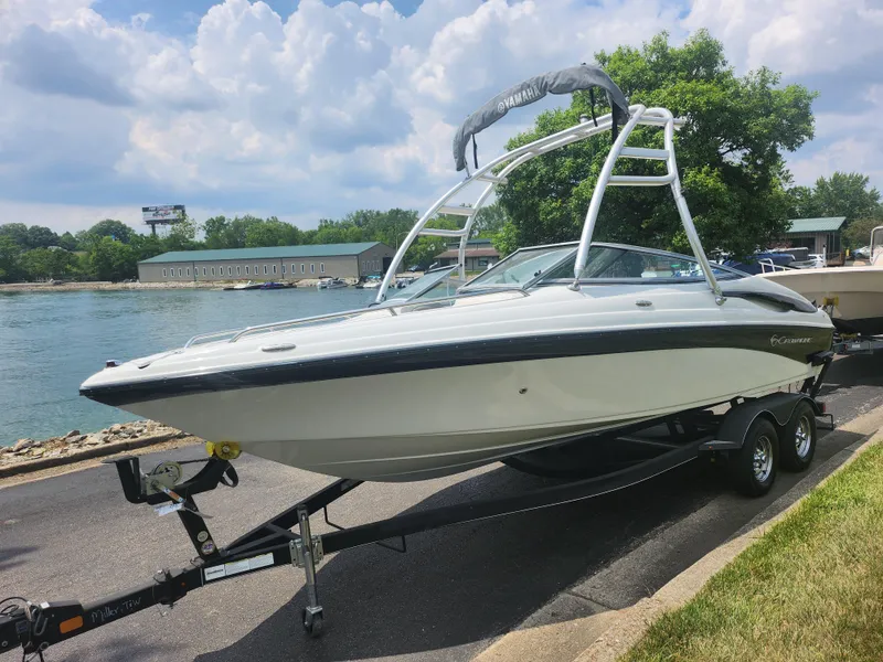 Slide: The Image of 2014 Crownline 21 SS boat on a trailer by the water. - 8
