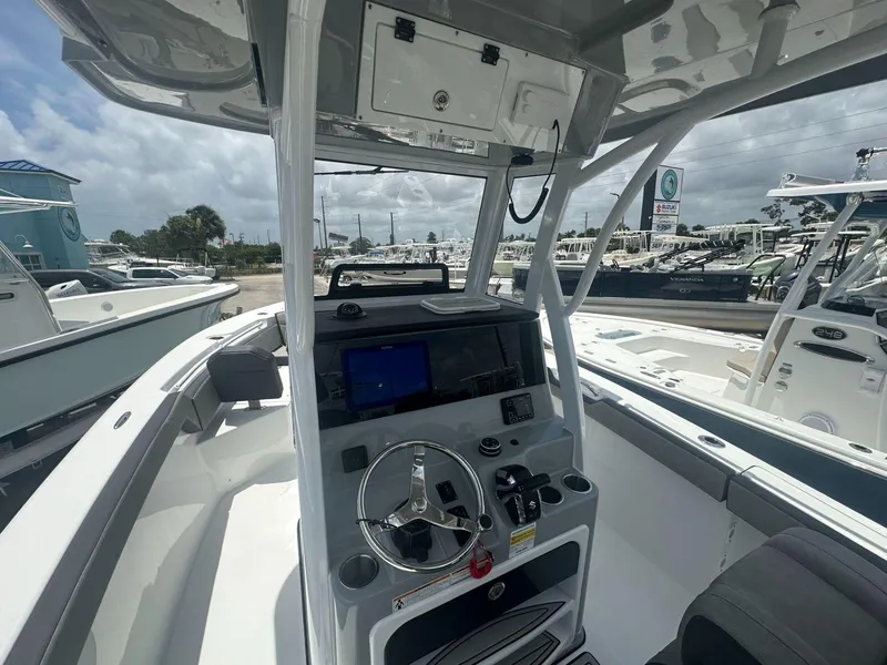 Slide: The Image of 2025 Sea Pro 245 FLX boat interior with modern dashboard and steering wheel. - 4
