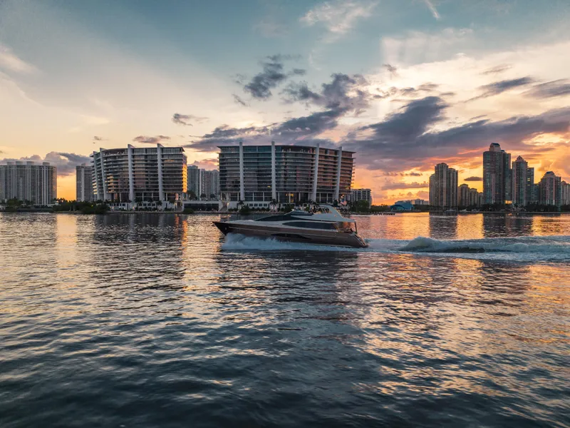 Slide: The Image of Luxury Riva 75 Venere yacht cruising at sunset near modern city skyline, 2012 model. - 15